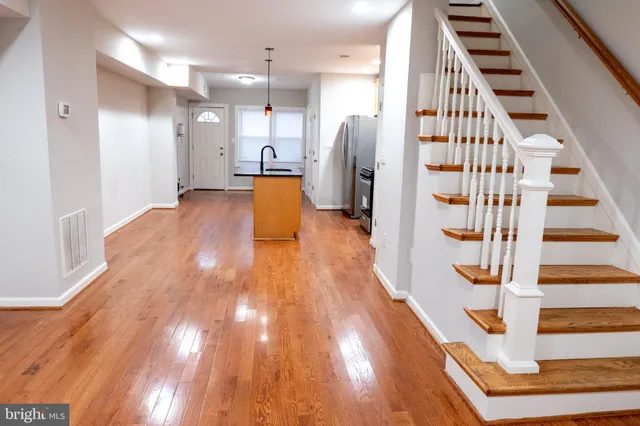 a view of entryway with wooden floor and stairs