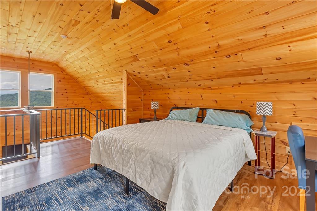 1299 Fox Rdg Trail Marion, NC 28752 - Photo 15 of 23 a spacious bedroom with a bed and wooden floor