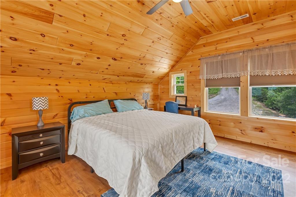 1299 Fox Rdg Trail Marion, NC 28752 - Photo 16 of 23 a bedroom with a bed and wooden floor