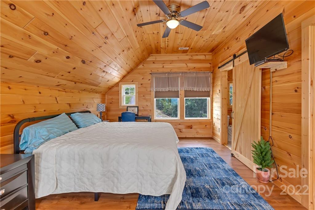 1299 Fox Rdg Trail Marion, NC 28752 - Photo 17 of 23 a bedroom with a bed and wooden floor