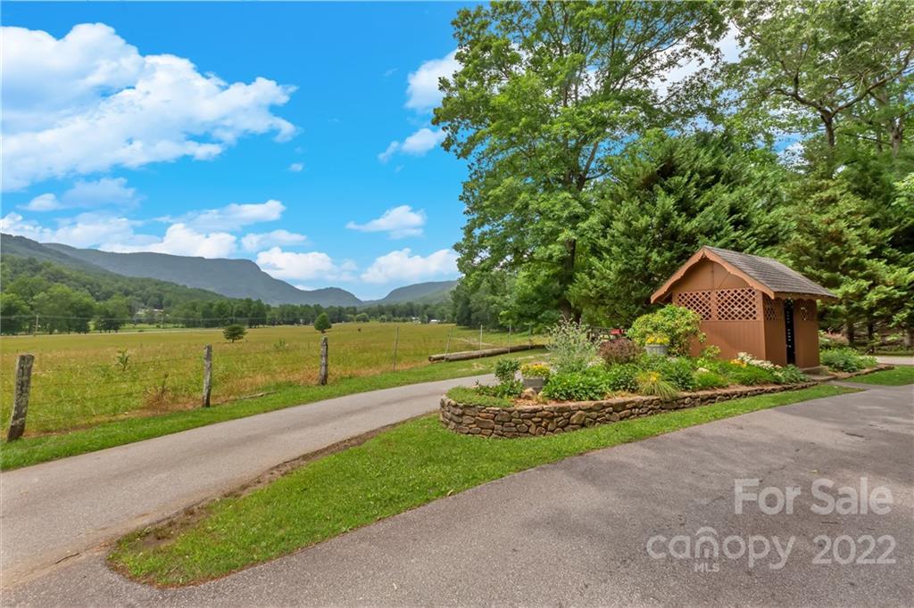 1299 Fox Rdg Trail Marion, NC 28752 - Photo 22 of 23 a view of a garden with a building in the background