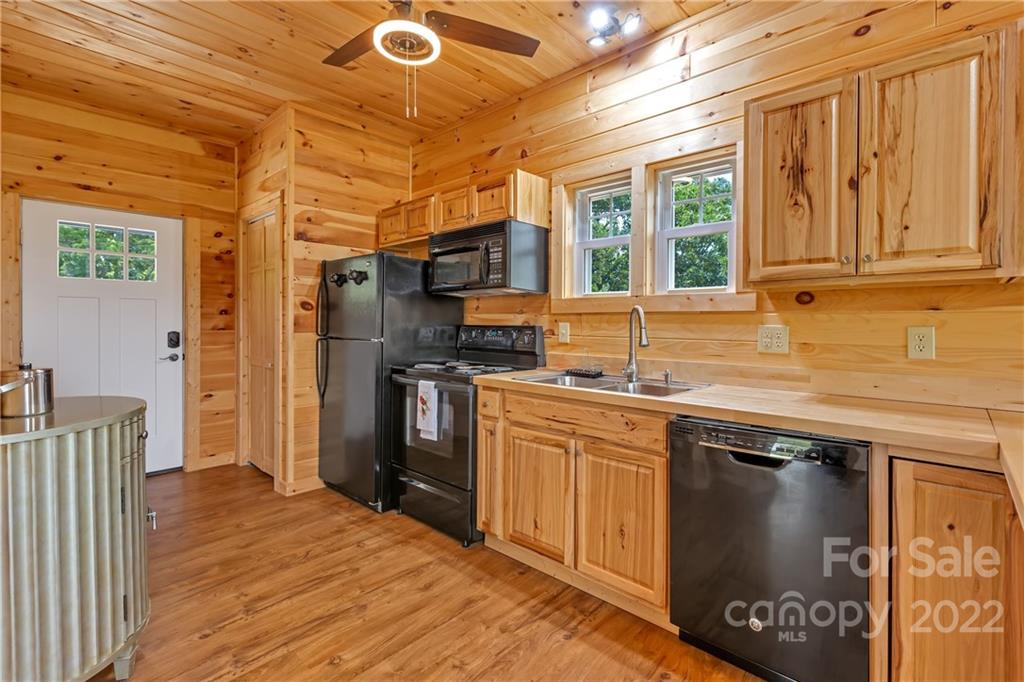 1299 Fox Rdg Trail Marion, NC 28752 - Photo 5 of 23 a kitchen with stainless steel appliances granite countertop a sink stove and refrigerator