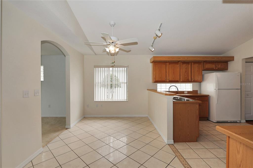 6318 Southwest 117th Loop Ocala, FL 34476 - Photo 17 of 60 a kitchen with stainless steel appliances granite countertop a refrigerator a sink dishwasher a stove with white cabinets