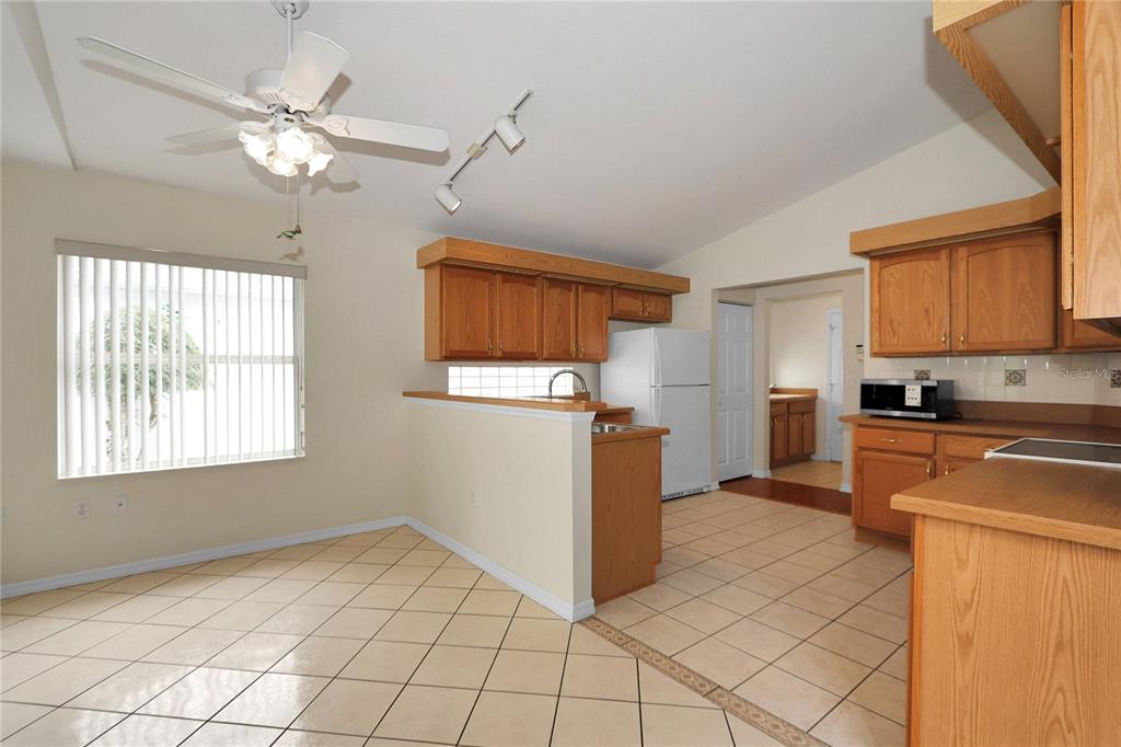 6318 Southwest 117th Loop Ocala, FL 34476 - Photo 18 of 60 a kitchen with cabinets and window