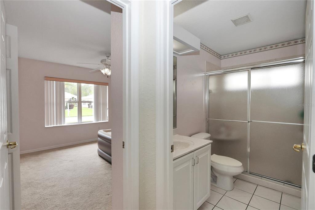 6318 Southwest 117th Loop Ocala, FL 34476 - Photo 24 of 60 a bathroom with a granite countertop toilet a sink a shower and a mirror