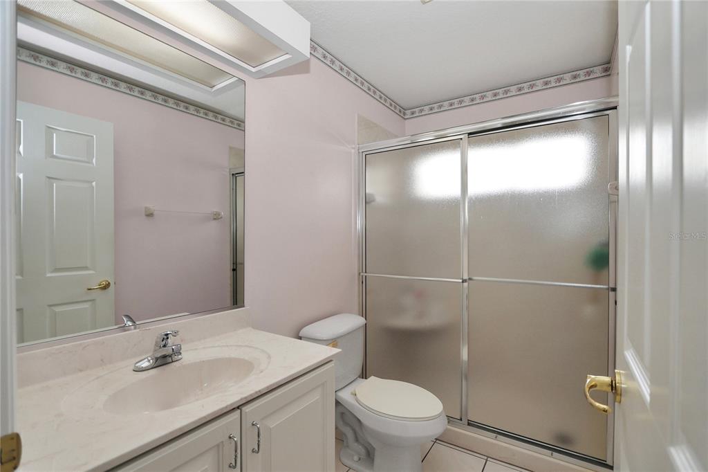 6318 Southwest 117th Loop Ocala, FL 34476 - Photo 25 of 60 a bathroom with a sink mirror vanity and toilet