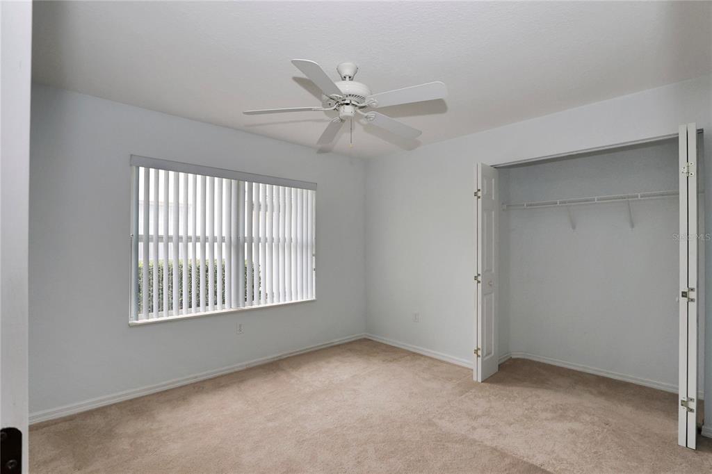 6318 Southwest 117th Loop Ocala, FL 34476 - Photo 29 of 60 an empty room with windows and fan