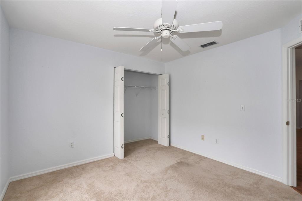 6318 Southwest 117th Loop Ocala, FL 34476 - Photo 30 of 60 an empty room with windows and fan