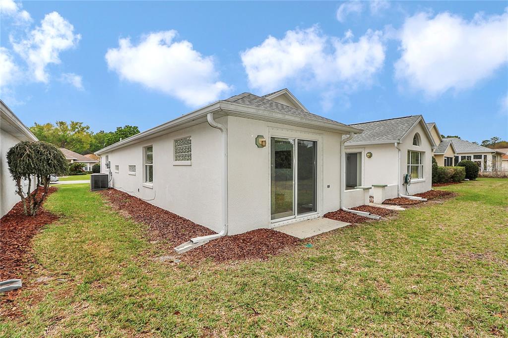 6318 Southwest 117th Loop Ocala, FL 34476 - Photo 37 of 60 a view of a house with backyard and sitting area