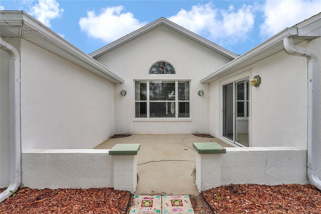 6318 Southwest 117th Loop Ocala, FL 34476 - Photo 38 of 60 a view of house with a large window and chandelier