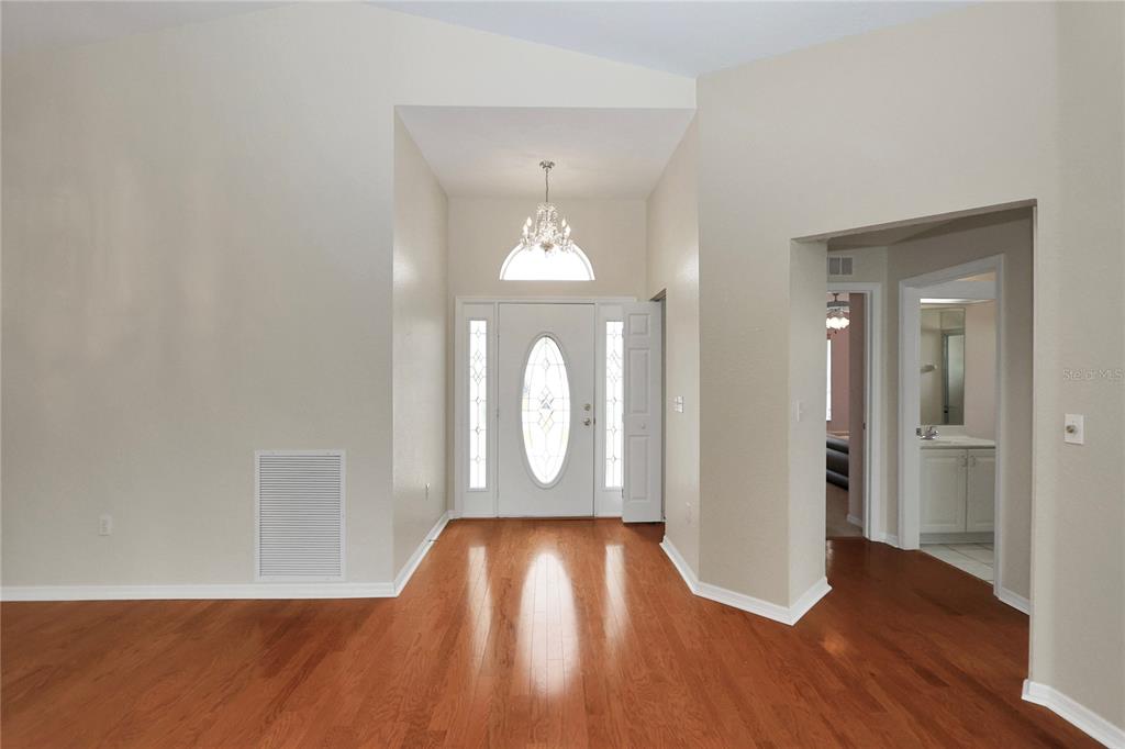6318 Southwest 117th Loop Ocala, FL 34476 - Photo 5 of 60 a view of empty room with wooden floor and fan