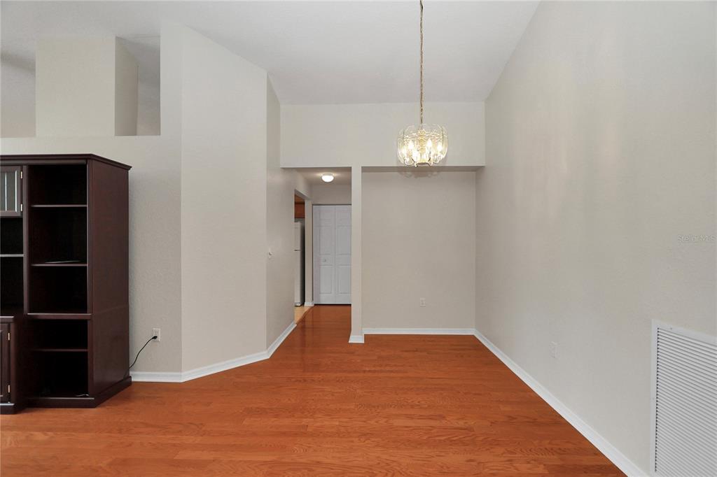 6318 Southwest 117th Loop Ocala, FL 34476 - Photo 7 of 60 a view of empty room with wooden floor and fan