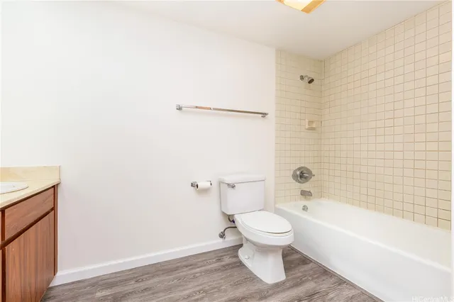a bathroom with a toilet and a bath tub