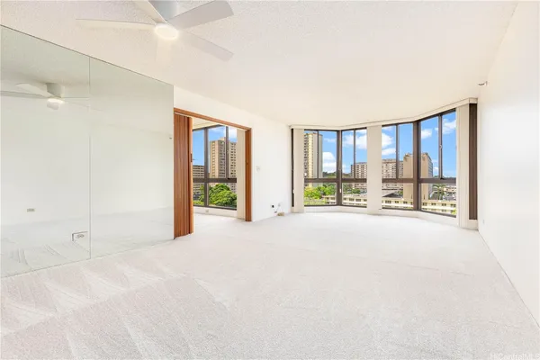a big room with a balcony and large window