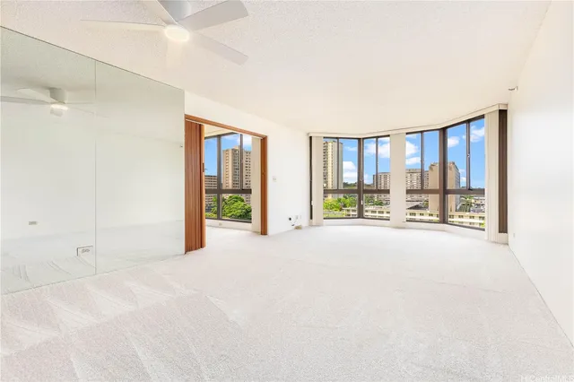 a big room with a balcony and large window