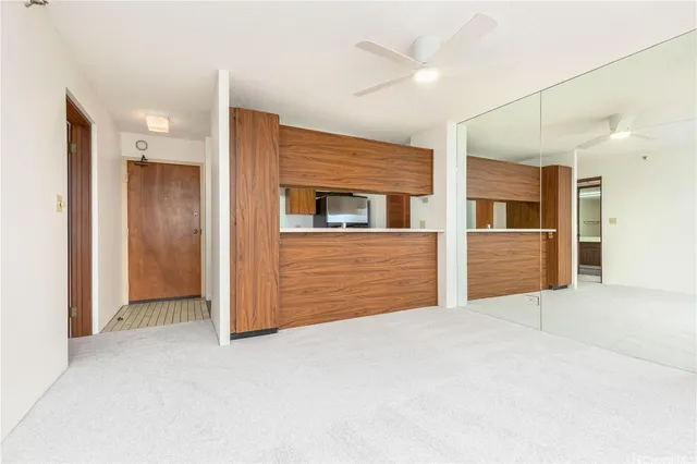 a view of an empty room with closet and cabinet