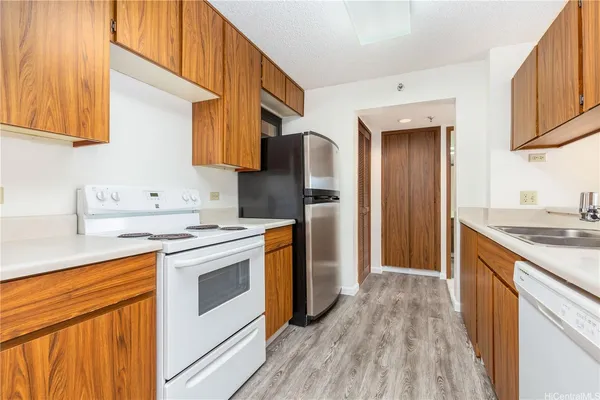 a kitchen with stainless steel appliances granite countertop a stove a sink and a refrigerator