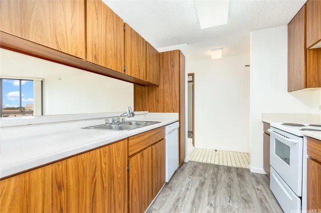 a kitchen with a stove a sink and a refrigerator