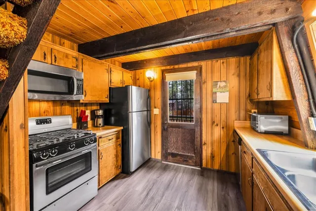 a view of a kitchen with furniture and wooden floor