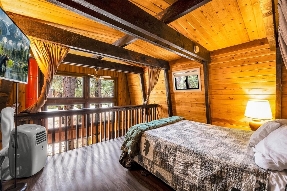 39656 Forest Road Big Bear Lake, CA 92315 - Photo 17 of 40 a bedroom with a bed and wooden floor