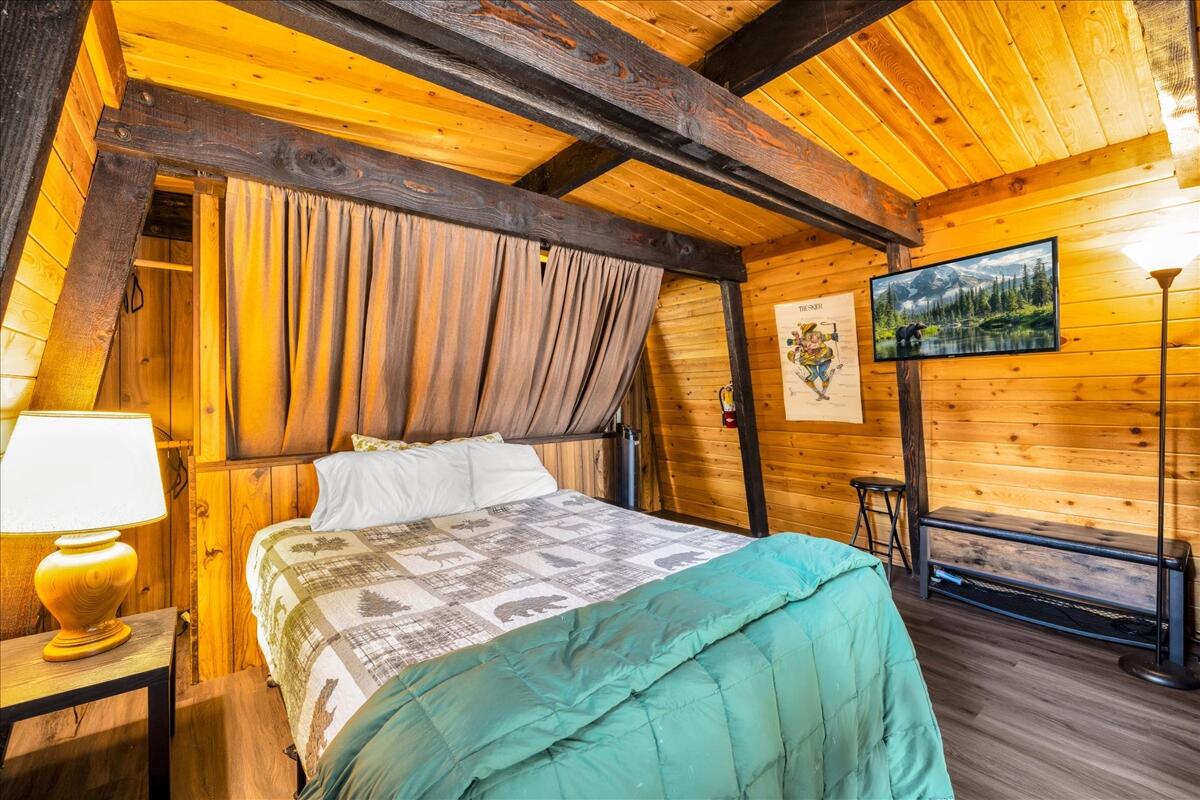 39656 Forest Road Big Bear Lake, CA 92315 - Photo 20 of 40 a bedroom with a bed and large windows