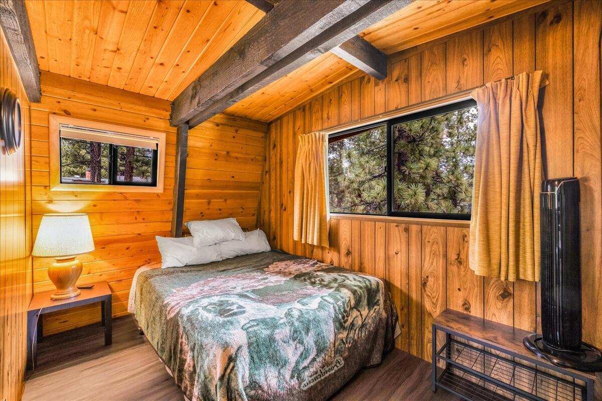 39656 Forest Road Big Bear Lake, CA 92315 - Photo 22 of 40 a bedroom with a bed and wooden floor