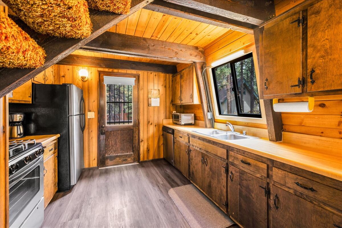 39656 Forest Road Big Bear Lake, CA 92315 - Photo 10 of 40 a view of a kitchen with a sink and a window