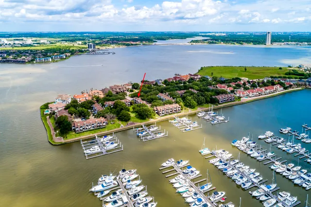 front view of a house with a potted plant and a large window