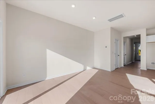 a view of an empty room with glass door