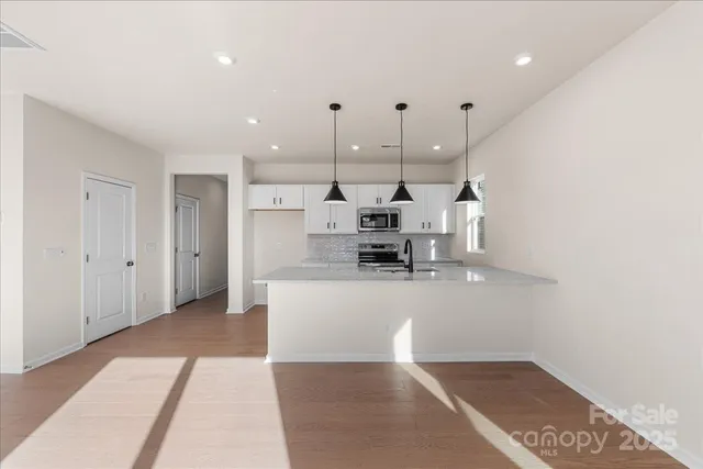 a view of kitchen with stainless steel appliances refrigerator and stove