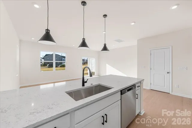 a kitchen with a sink a counter space and a stove