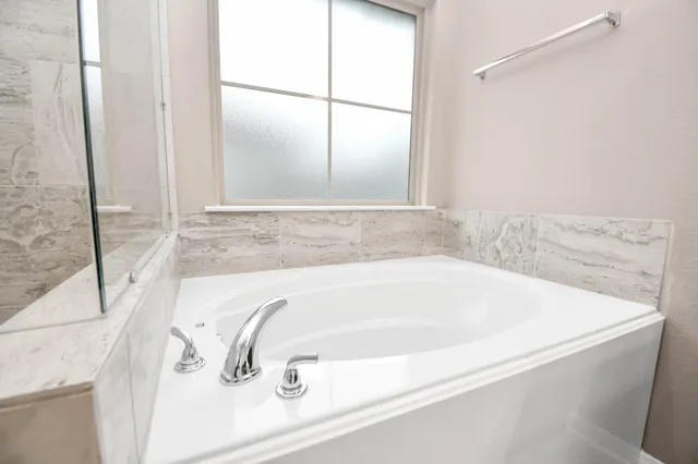 a bath tub sitting next to a window