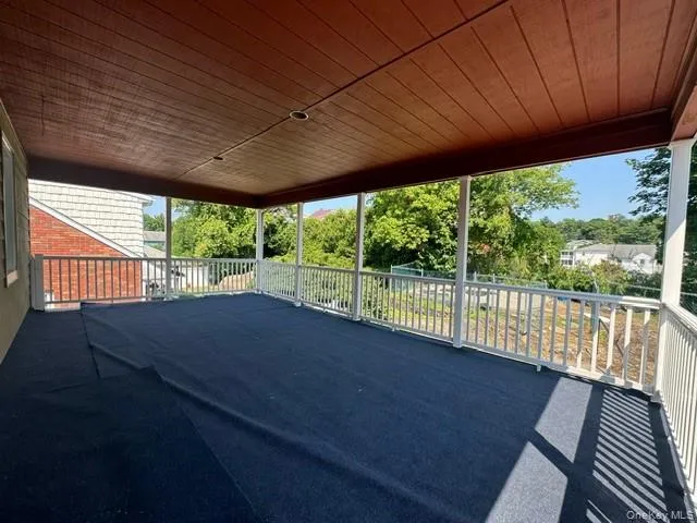 a view of a deck hardwood and floor to ceiling window