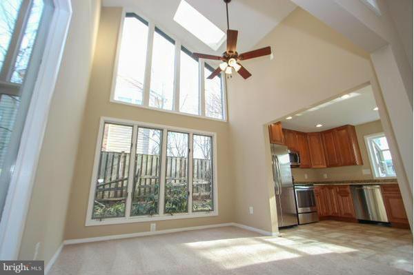 a view of a kitchen with furniture and a ceiling fan
