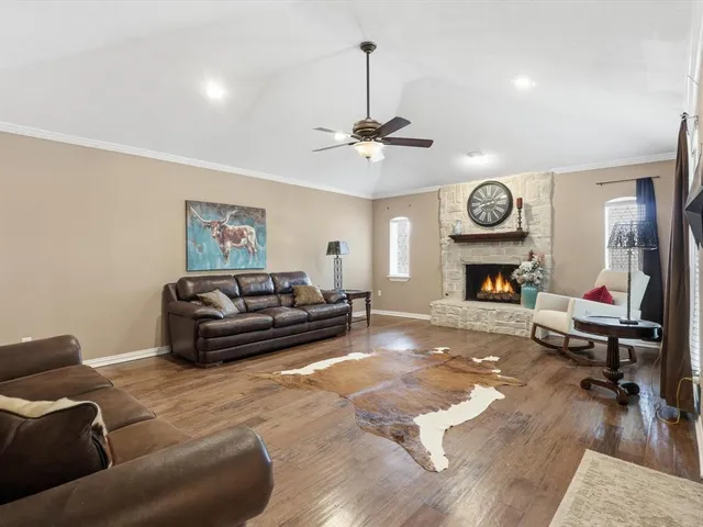 a living room with furniture a clock and a fireplace