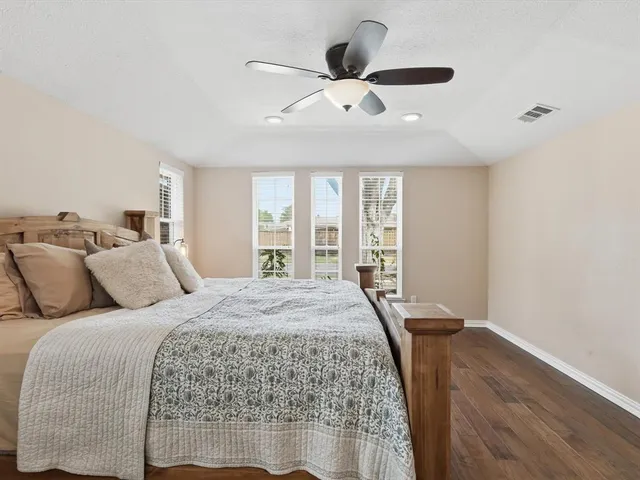 a bedroom with a large bed and a large window