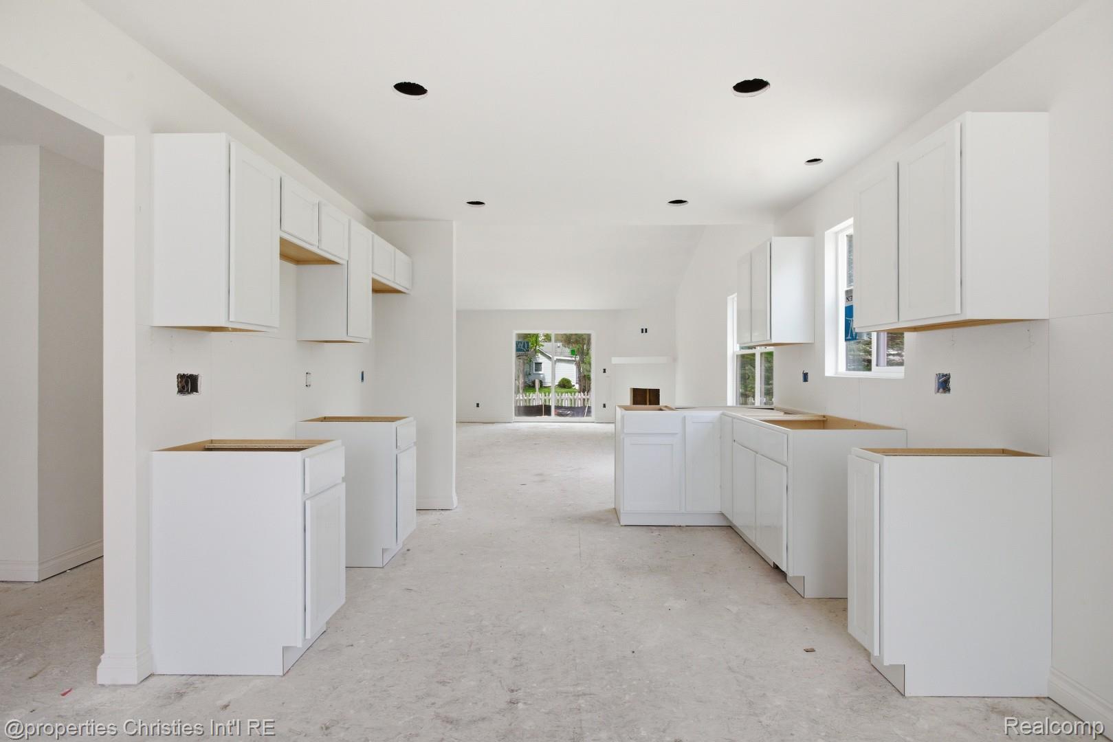 757 Nelson's Ridge Drive, Unit 2 Howell, MI 48843 - Photo 8 of 25 Kitchen area featuring recessed lighting, white cabinetry, multiple windows, and an open layout