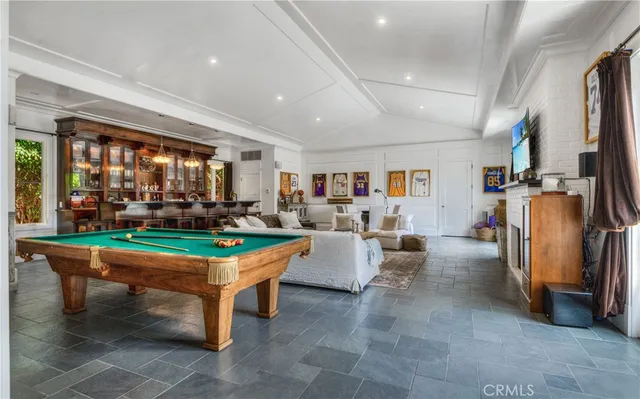 a living room with patio furniture and a floor to ceiling window