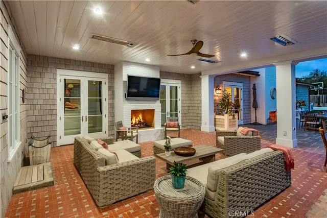 a living room with furniture a fireplace and a flat screen tv