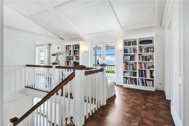 a view of a hallway with wooden floor and entryway