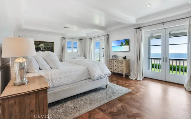 a bedroom with a balcony a bed and a tv on table