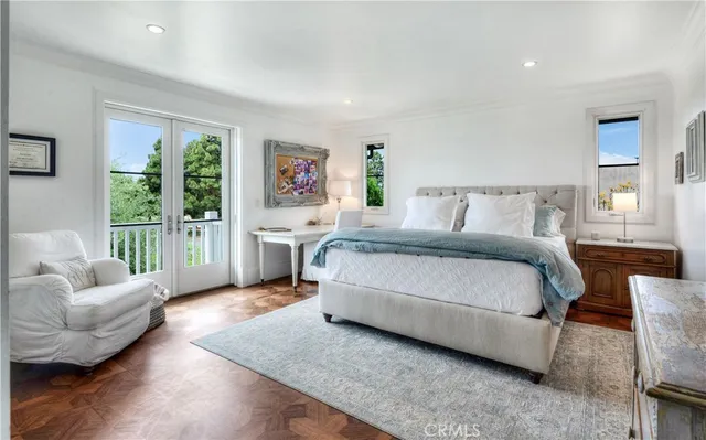 a spacious bedroom with a bed couch and a large window