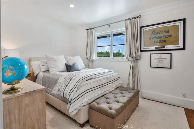 a bedroom with bed and a window