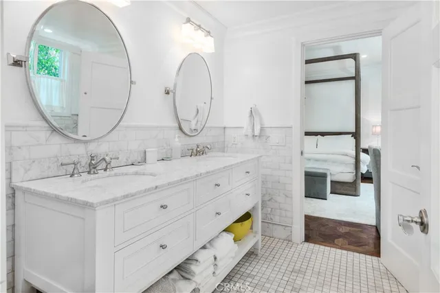 a bathroom with a double vanity sink and a mirror