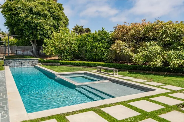 a view of a backyard with swimming pool