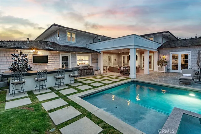a view of a house with swimming pool and sitting area