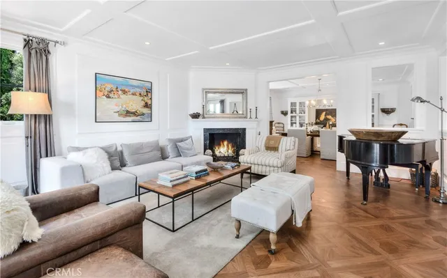 a living room with furniture a rug and a fireplace