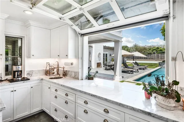a kitchen with sink and cabinets