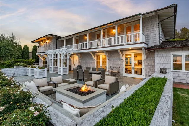 a view of a house with couches chairs and wooden floor