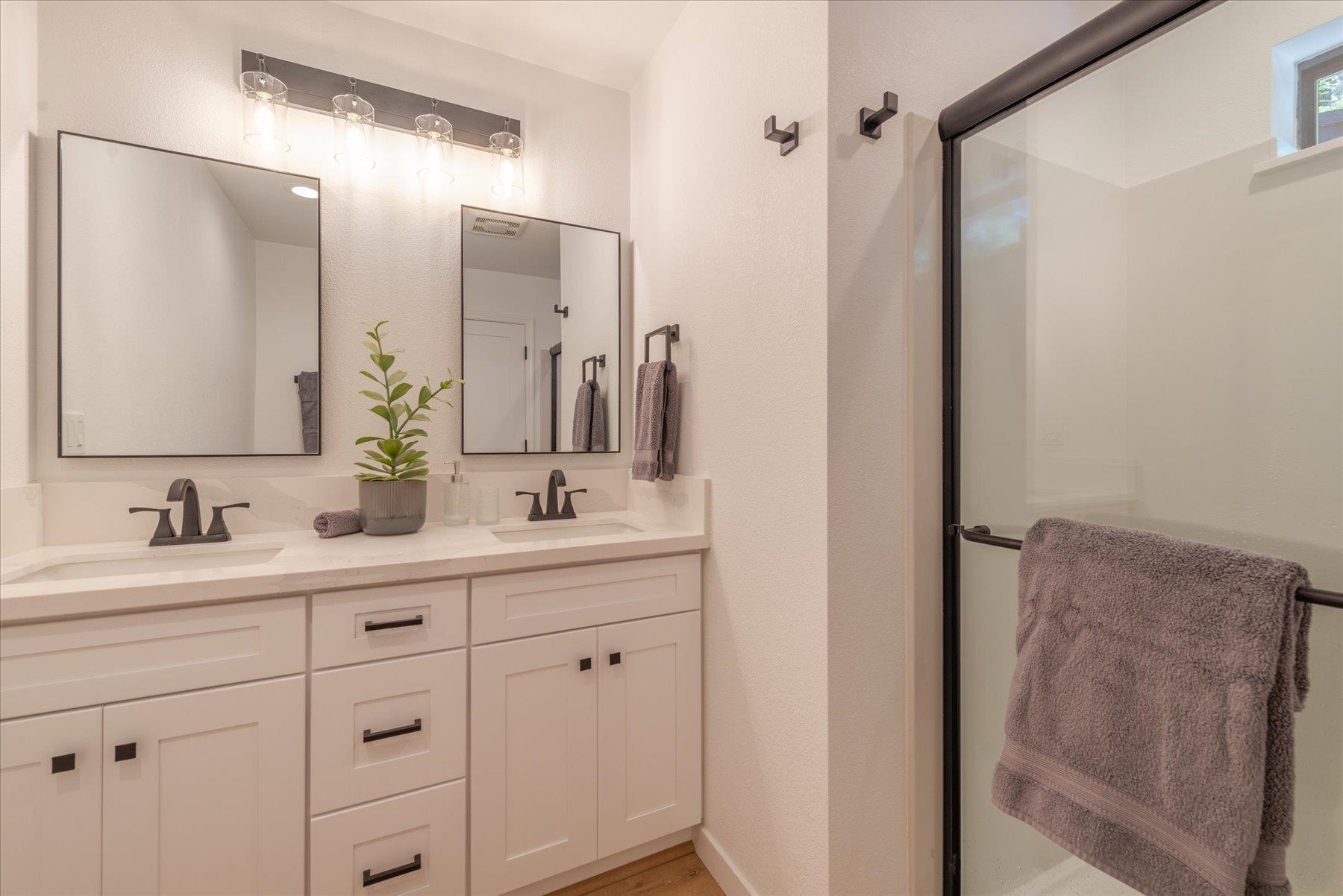 12839 Palisade Street Truckee, CA 96161 - Photo 10 of 21 a bathroom with a double vanity sink mirror and shower